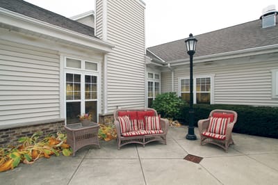Outdoor seating area with chairs and plants