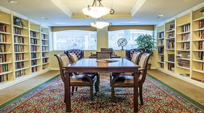 Cozy library space with bookshelves and a large table