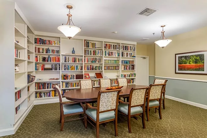 Cozy reading room with bookshelves and a large table