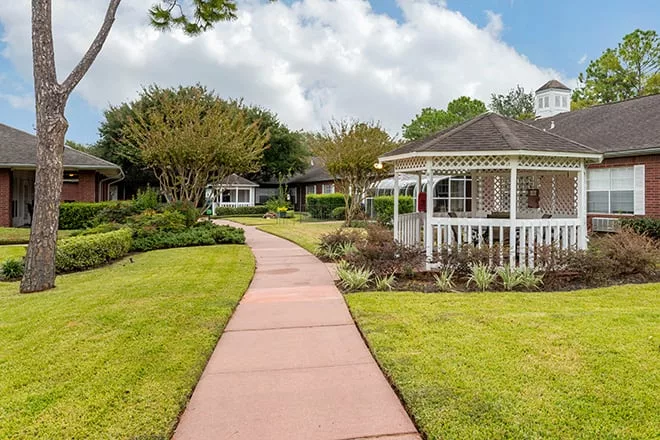 Pathway leading to a gazebo in landscaped garden