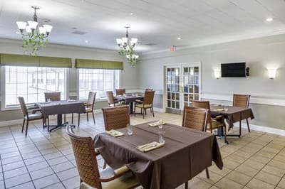 Dining room with neatly set tables and chairs