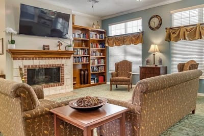 Cozy common area with seating and bookshelf
