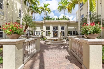 Lush courtyard with a fountain and palm trees