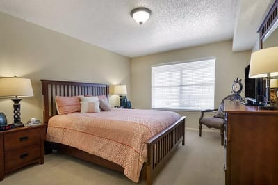 A cozy private resident room with a bed and natural light