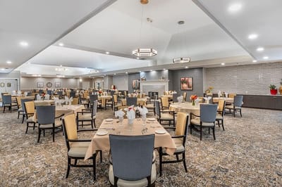 Bright dining room with tables set for meals