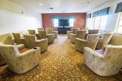 A cozy common area with chairs for residents