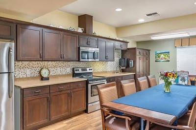 Bright, modern kitchen and dining area with flowers