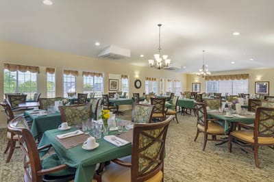 Dining area set for residents with flowers on the table