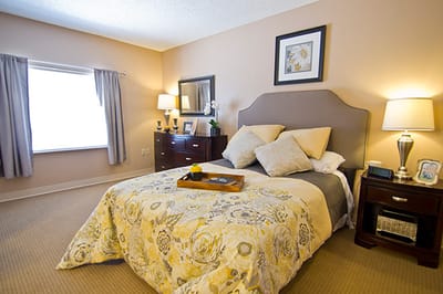 Brightly decorated private resident room with floral bedding