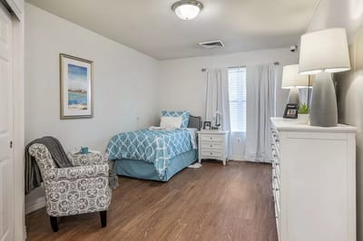 Cozy resident room with a bed and chair