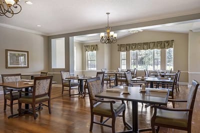 Dining room with tables and chairs, well-lit