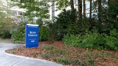 Facility logo sign in front of Budd Terrace