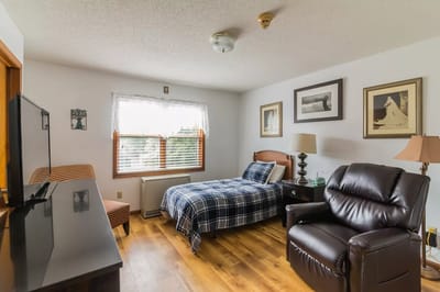 Cozy private resident room with a bed and seating area