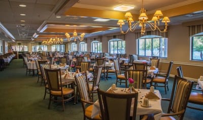 Dining area set up for residents with flowers on tables