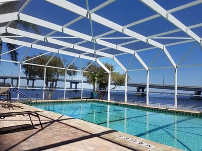Indoor pool area with clear water and bridge view
