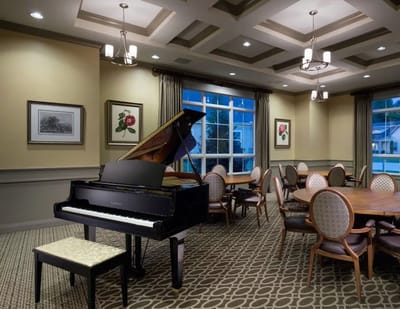 Interior common area with a grand piano and dining tables