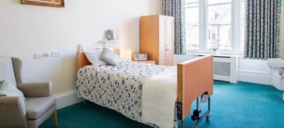 Brightly decorated resident room with a bed and furnishings