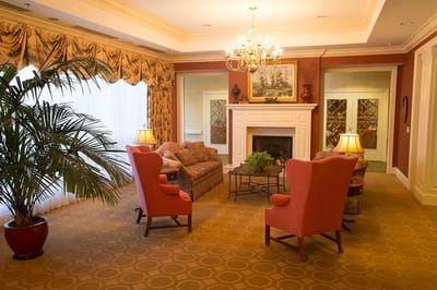 A cozy common area with comfortable seating and a fireplace