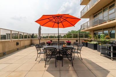 Outdoor terrace with tables and an umbrella