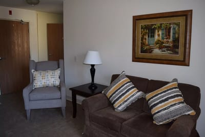 Cozy living room area with armchair and artwork