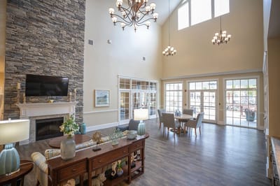 Bright common area with stone fireplace and seating