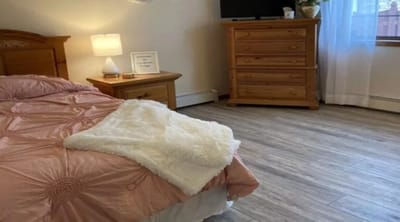 Bright resident room with a cozy bed and furniture
