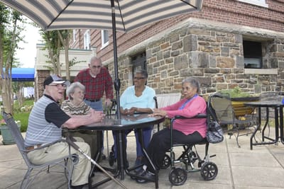 Residents enjoying conversation at an outdoor table