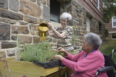 Two residents gardening outdoors