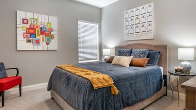Well-decorated private resident room with a bed