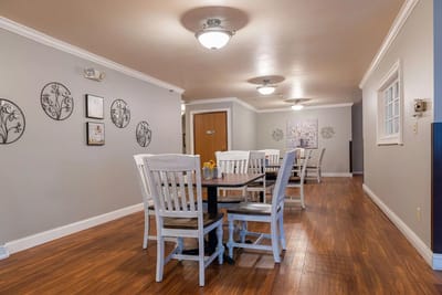 Bright common area with dining table and chairs