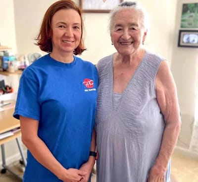 Staff member with a resident in a well-lit room
