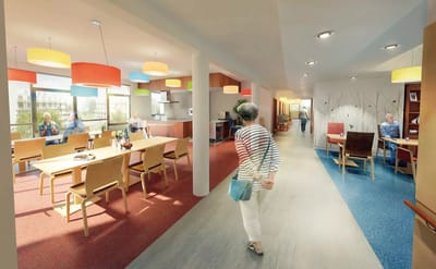 Interior scene of a bright, modern common area with residents