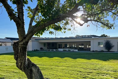 Exterior view of a facility building with landscaped lawn