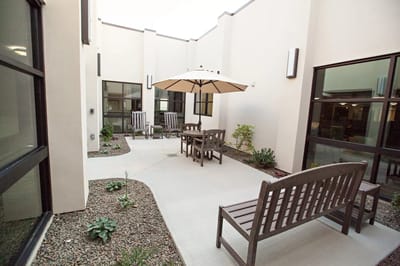 Outdoor seating area with benches and umbrella