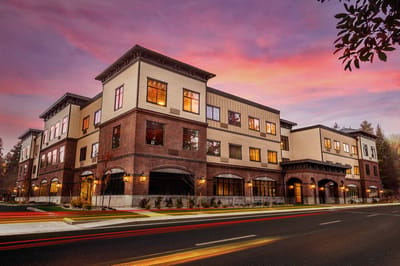Exterior view of Cedar Creek Memory Care Community at sunset