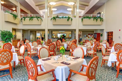 Dining area with tables and chairs set for a meal