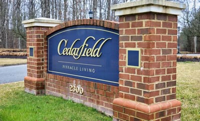 Cedarfield facility entrance sign with name and address