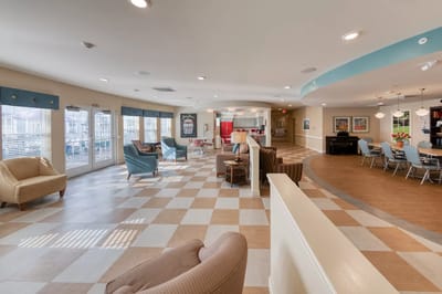 Bright common area with seating and large windows