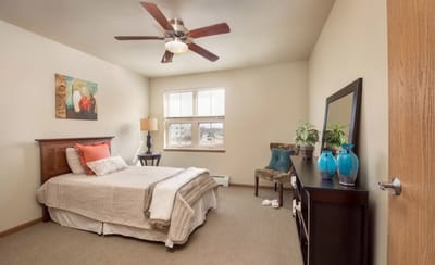 Brightly decorated private bedroom with furnishings