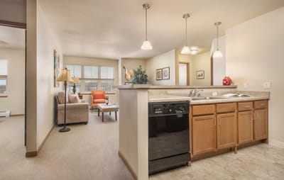 Brightly lit apartment-style living area with kitchen