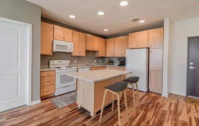 Modern kitchen interior with wooden cabinets and island