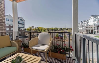Balcony view overlooking landscaped grounds and building