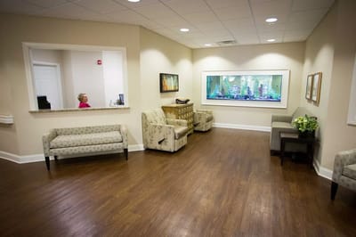 A bright common area with seating and an aquarium