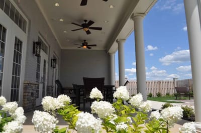 Outdoor patio area with flowers and furniture