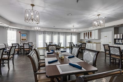 Bright dining area with tables and chairs set up