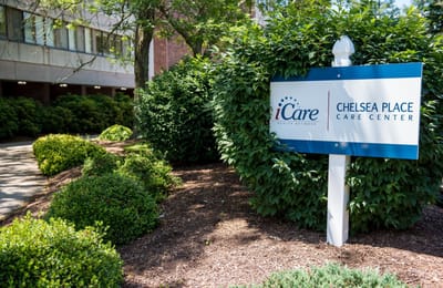 Exterior sign of Chelsea Place Care Center surrounded by greenery