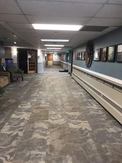 A well-lit corridor with seating and artwork