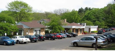 Exterior view of Chestnut Hill Lodge with parking area