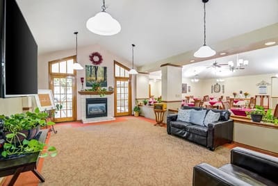 Common area with seating and fireplace in a senior living facility