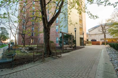 Outdoor pathway with seating and greenery